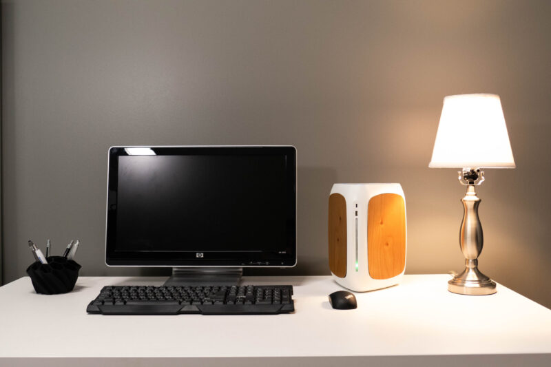 A desk with a computer and lamp