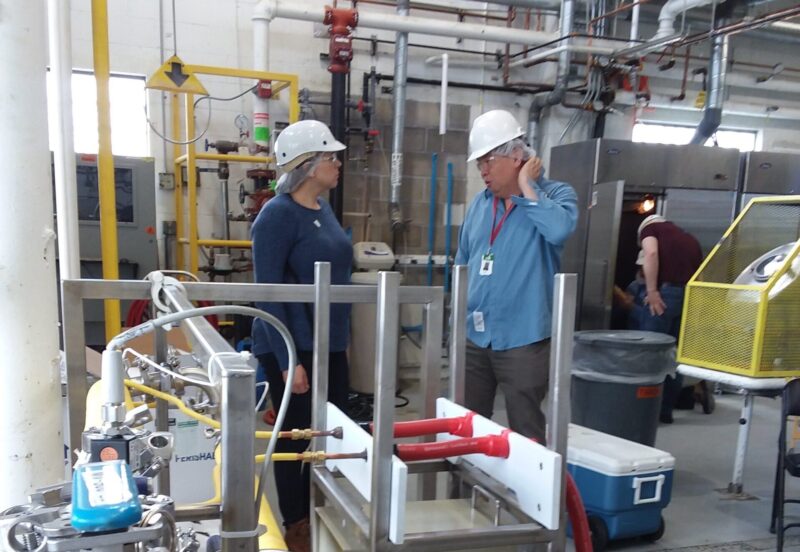 Two people standing in a lab talking