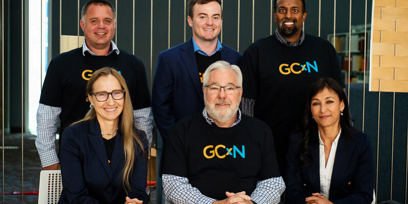 Six representatives from GCxN Cohort 6 sit at a table