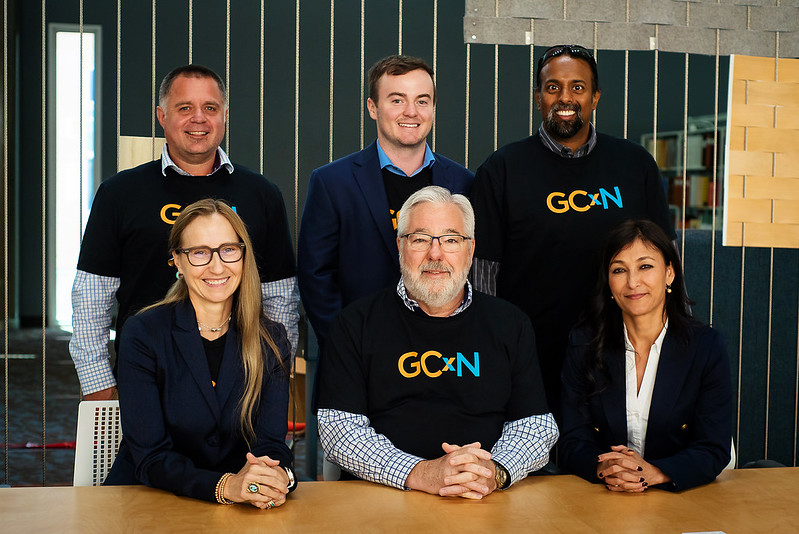 Six representatives from GCxN Cohort 6 sit at a table